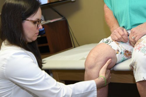 Sara Thompson evaluating knee